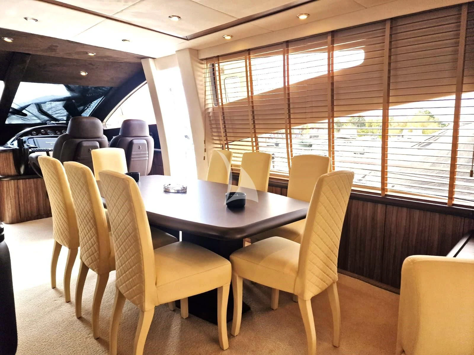 a table and chairs in a room aboard M FIVE Yacht for Charter