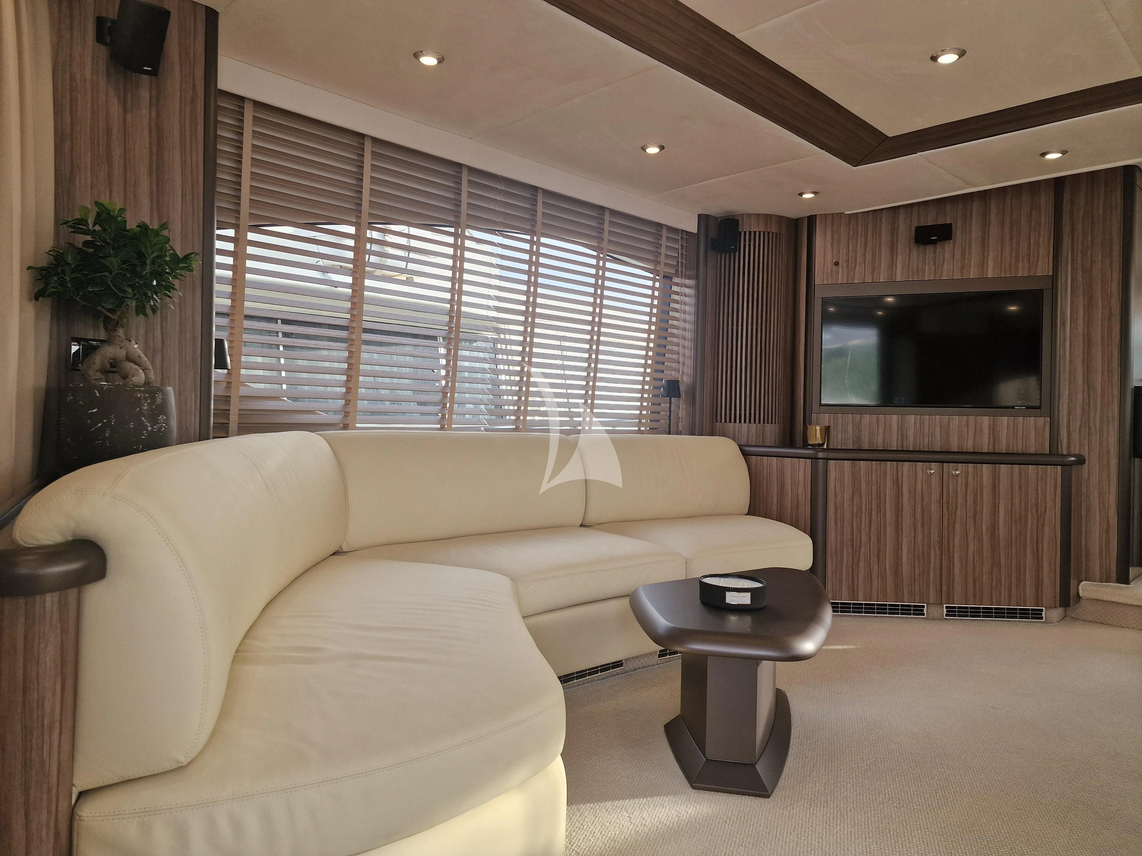 a living room with a couch and a television aboard M FIVE Yacht for Charter