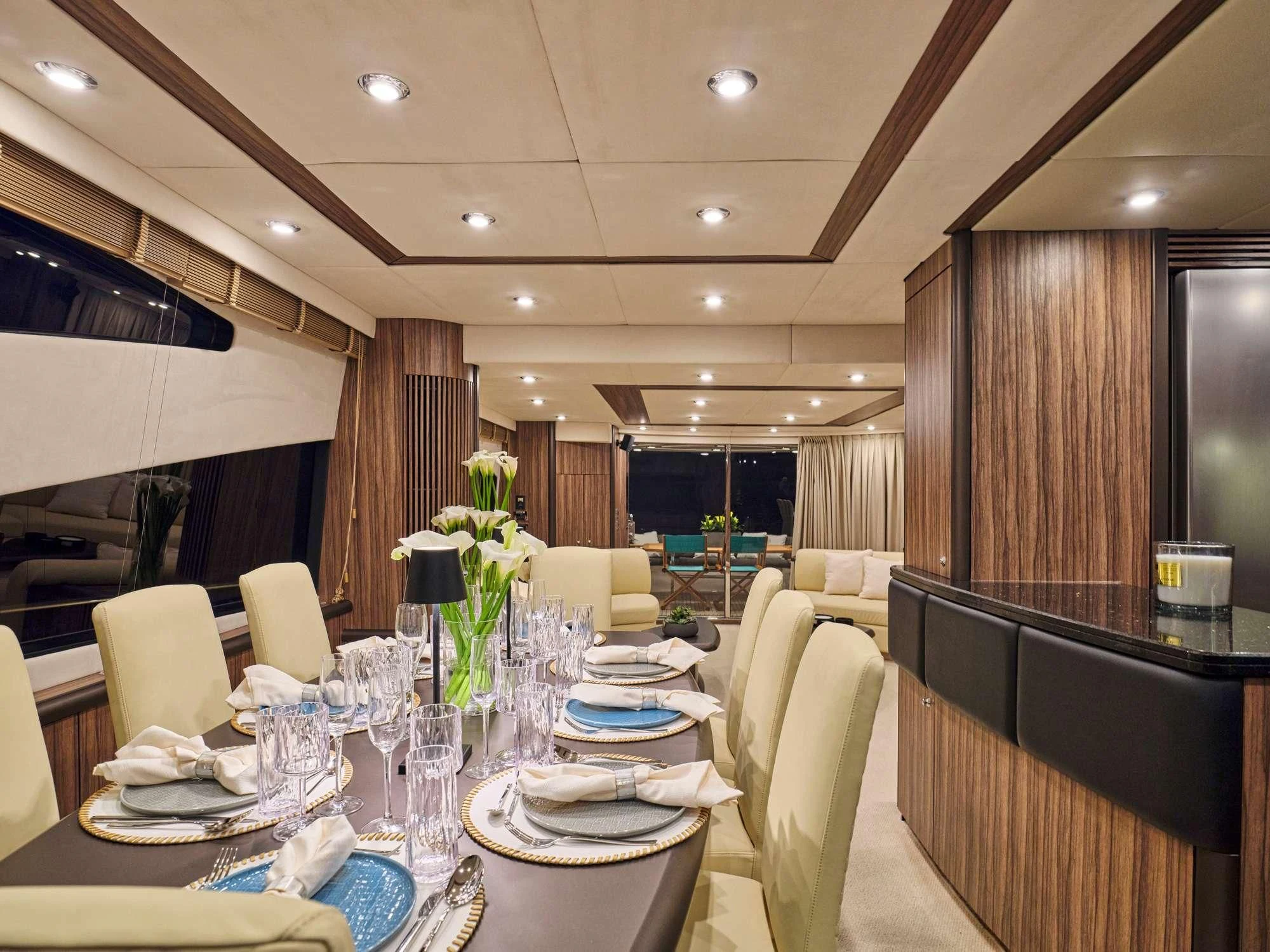 a room with tables and chairs aboard M FIVE Yacht for Charter