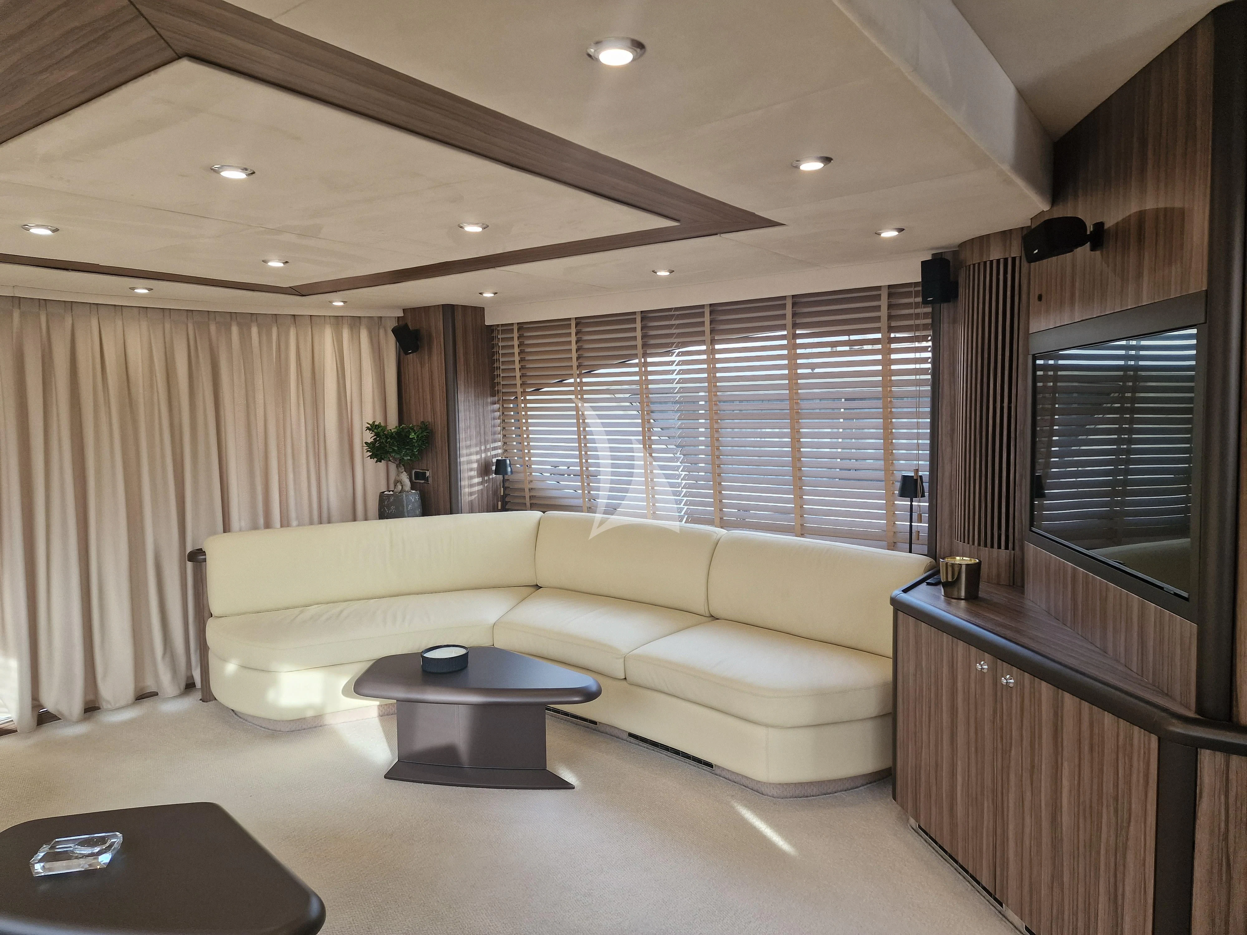 a living room with a couch and a coffee table aboard M FIVE Yacht for Charter