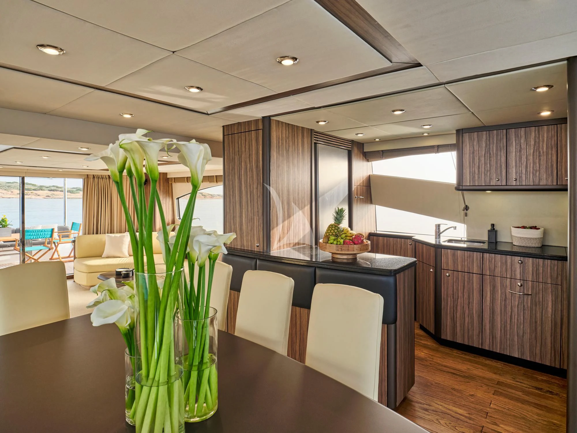 a kitchen with a large table and chairs aboard M FIVE Yacht for Charter