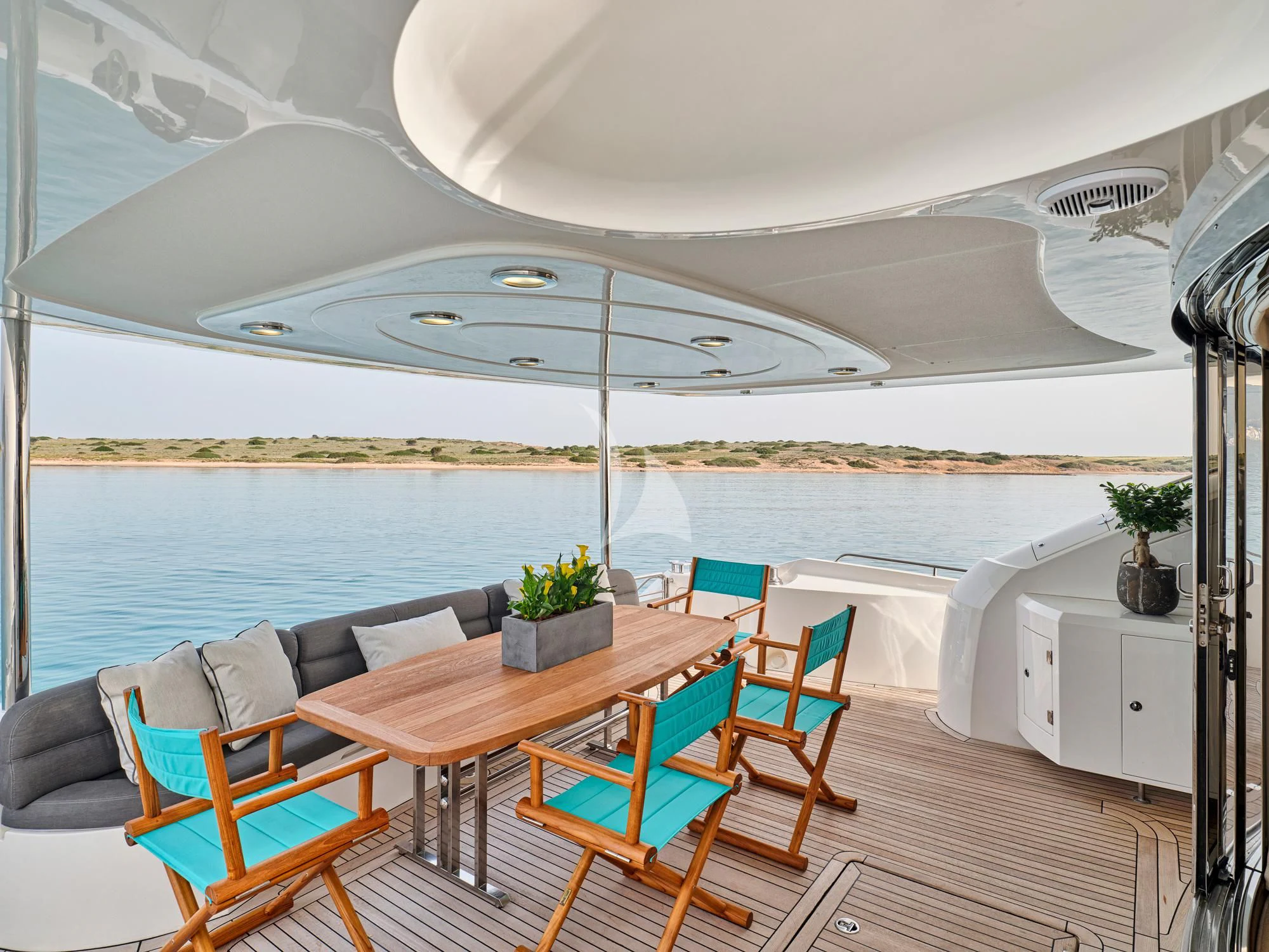 a table and chairs on a deck aboard M FIVE Yacht for Charter