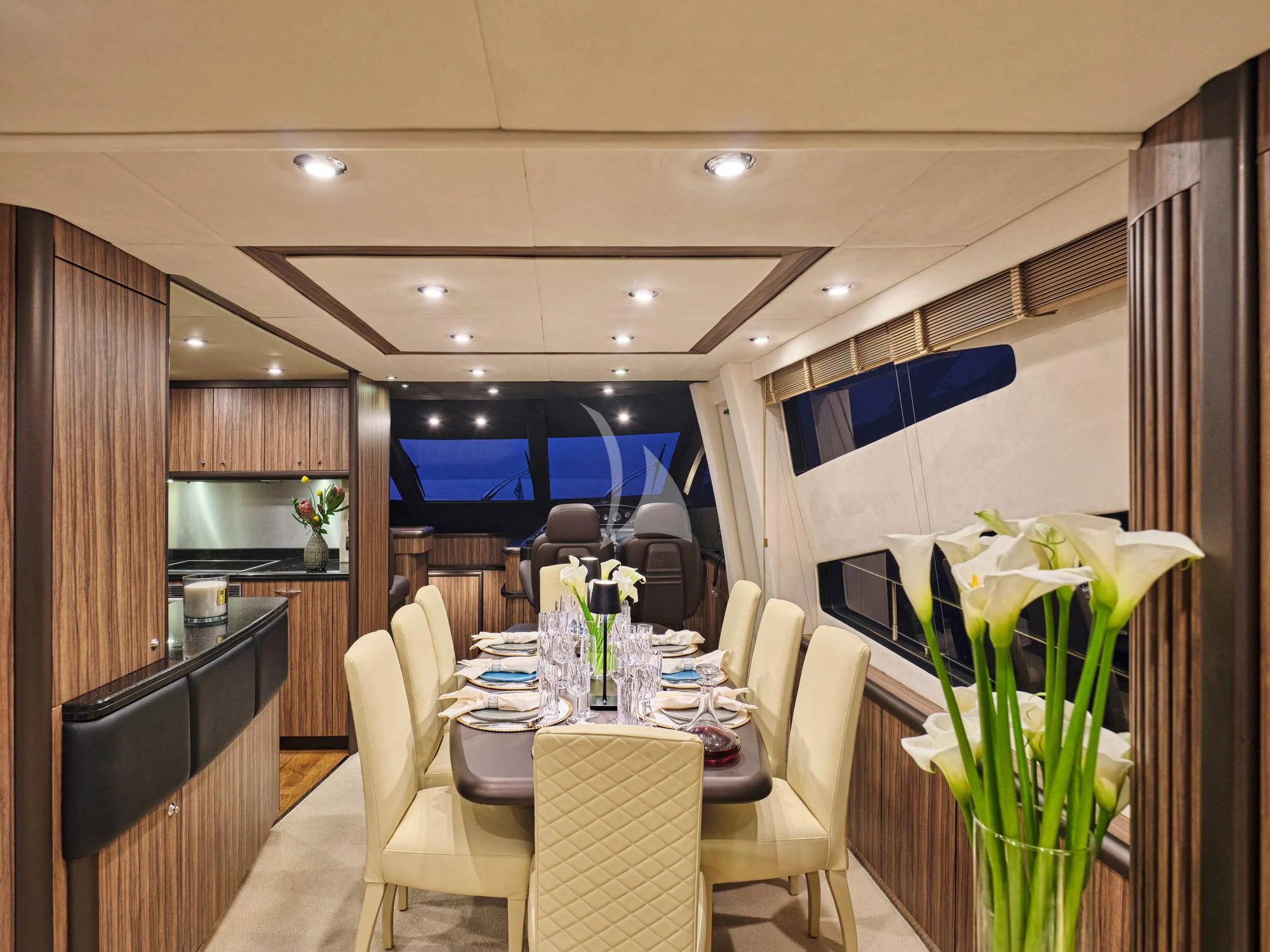a room with a table and chairs aboard M FIVE Yacht for Charter