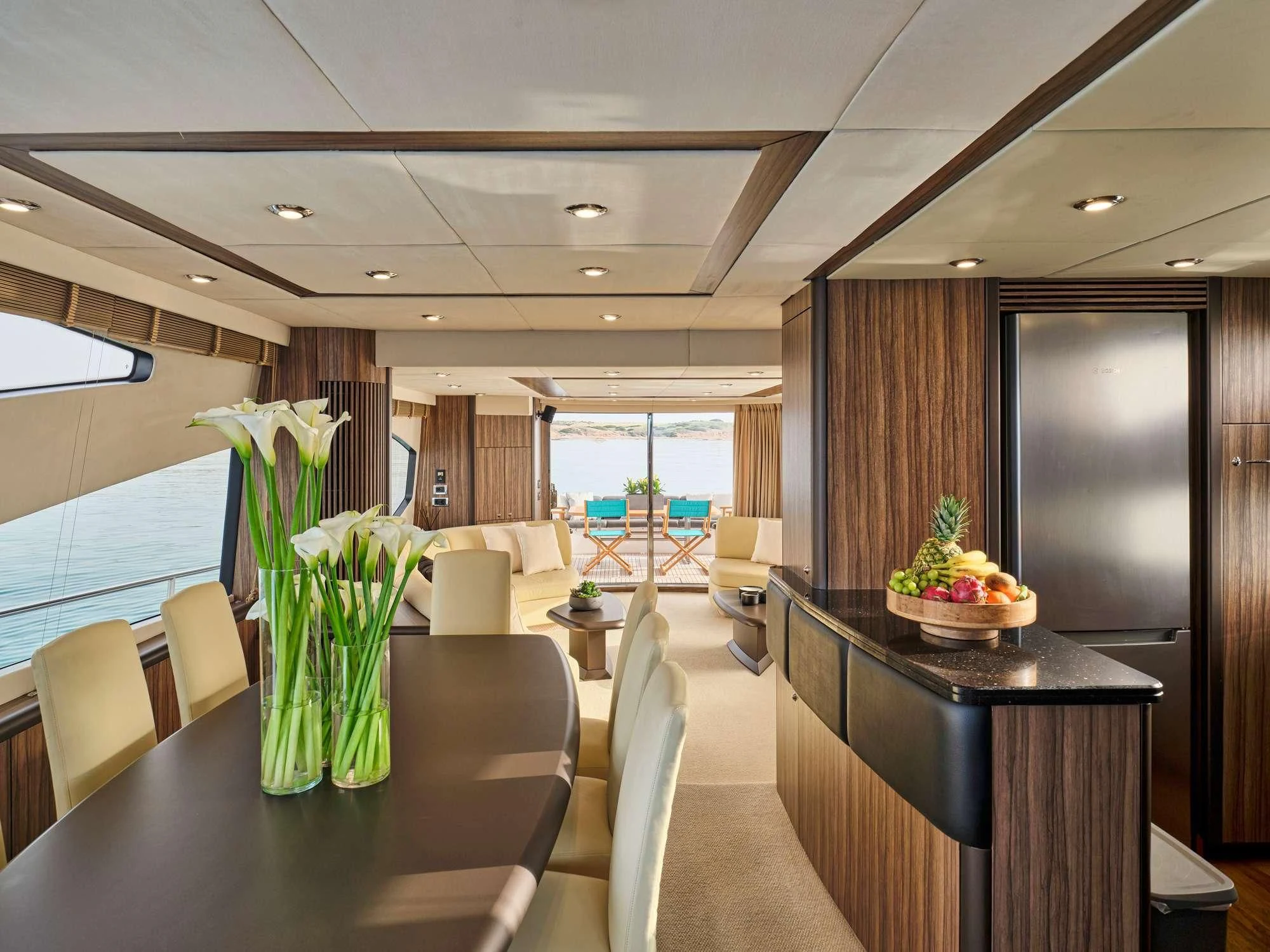a room with a table and chairs aboard M FIVE Yacht for Charter