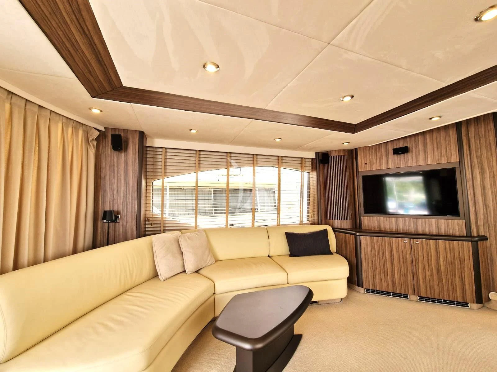 a living room with a couch and tv aboard M FIVE Yacht for Charter