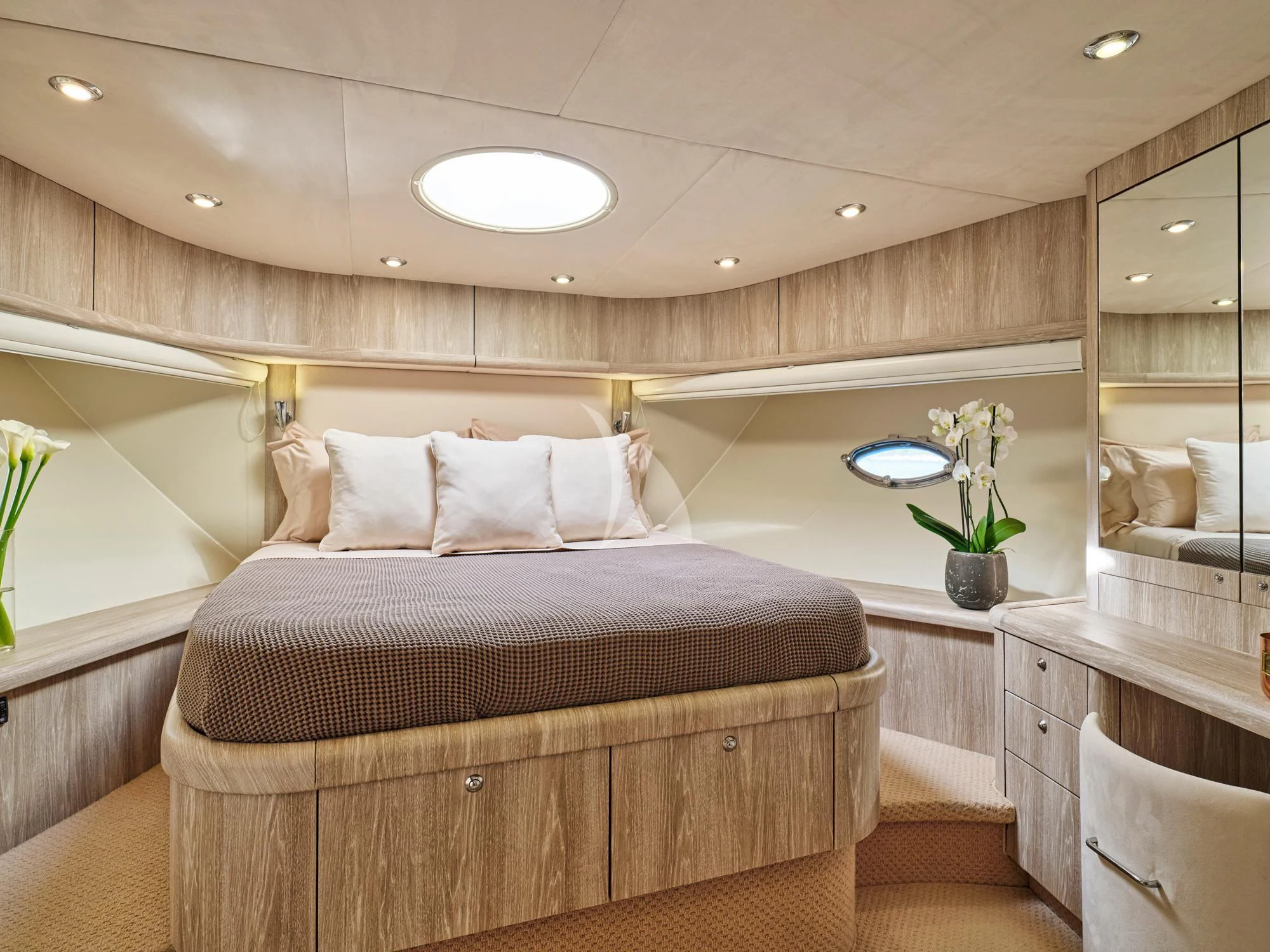 a bedroom with a bed and a plant in the corner aboard M FIVE Yacht for Charter