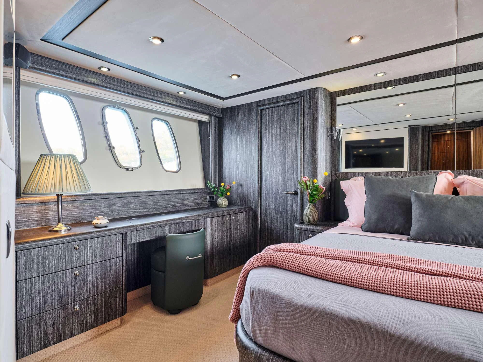 a bedroom with a bed and a desk aboard M FIVE Yacht for Charter