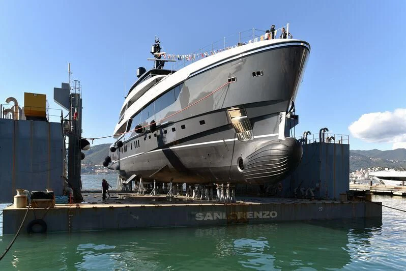 a large white boat docked at a dock aboard MY ALMA Yacht for Sale