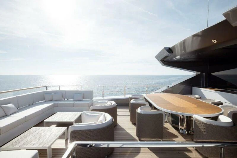 a room with a table chairs and a large body of water aboard MY ALMA Yacht for Sale