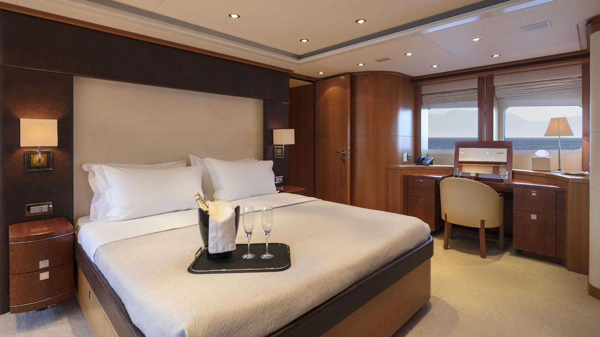a hotel room with a bed and wine glasses aboard L'EQUINOX Yacht for Sale