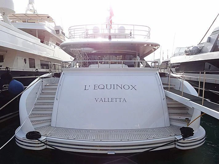 a white yacht in a harbor aboard L'EQUINOX Yacht for Sale