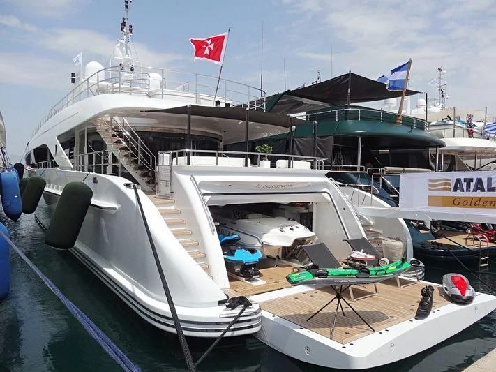a boat with a flag on the deck aboard L'EQUINOX Yacht for Sale