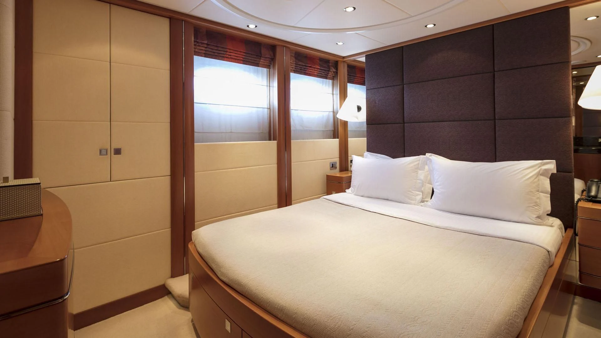 a room with a bed and a window aboard L'EQUINOX Yacht for Sale