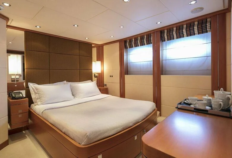 a room with a bed and a desk aboard L'EQUINOX Yacht for Sale