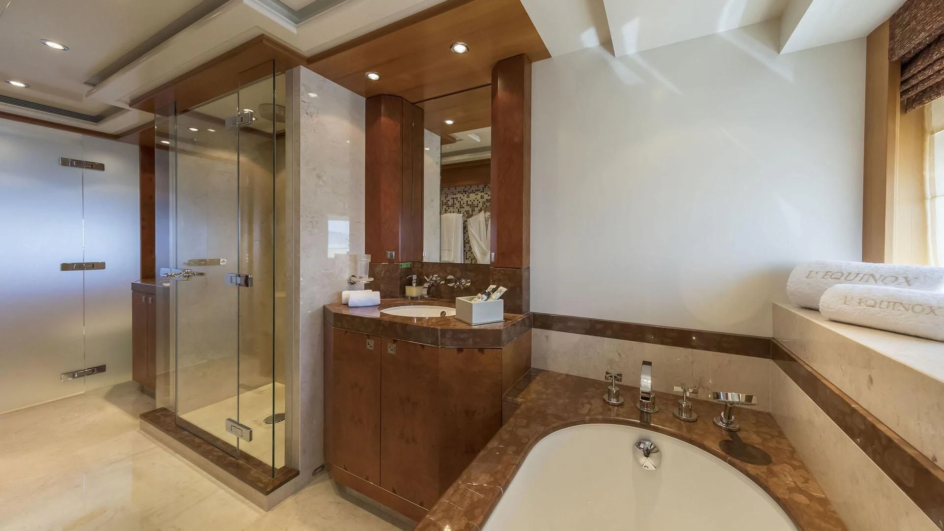 a bathroom with a large bathtub and a large mirror aboard L'EQUINOX Yacht for Sale