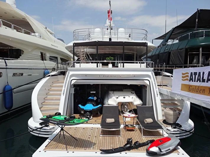 a boat with a table and chairs on it aboard L'EQUINOX Yacht for Sale