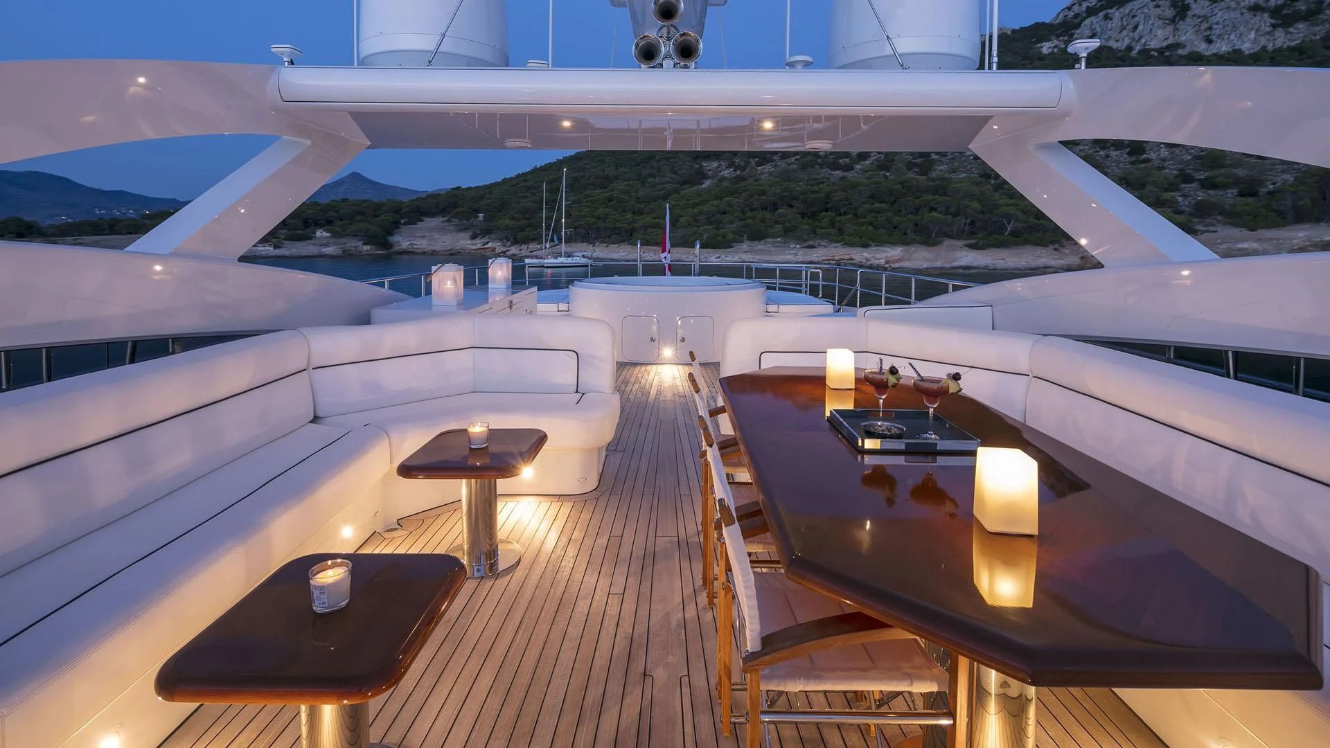 a deck with a view of a large lake and a large building aboard L'EQUINOX Yacht for Sale