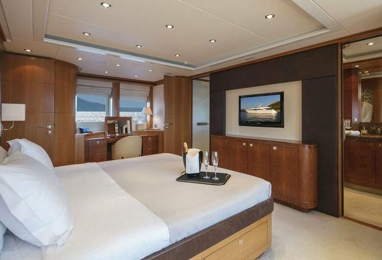 a hotel room with a bed and a tv aboard L'EQUINOX Yacht for Sale