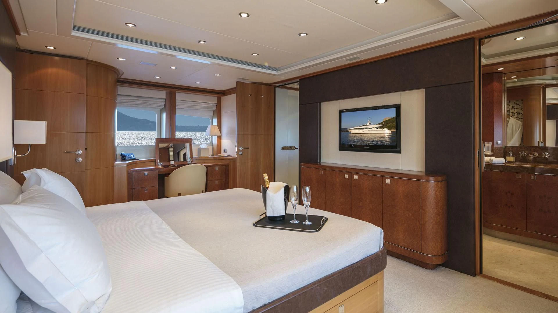 a hotel room with a bed and a tv aboard L'EQUINOX Yacht for Sale