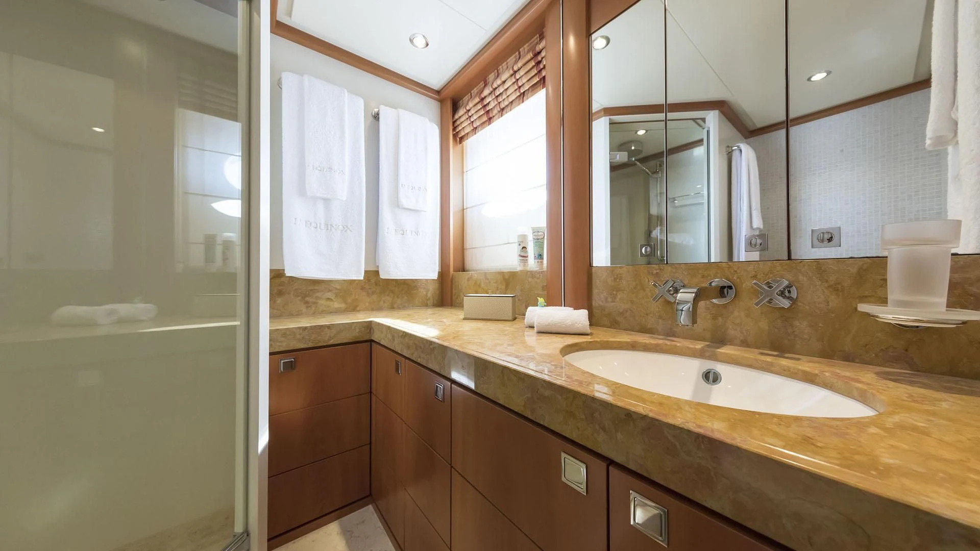 a bathroom with a countertop sink and mirrors aboard L'EQUINOX Yacht for Sale