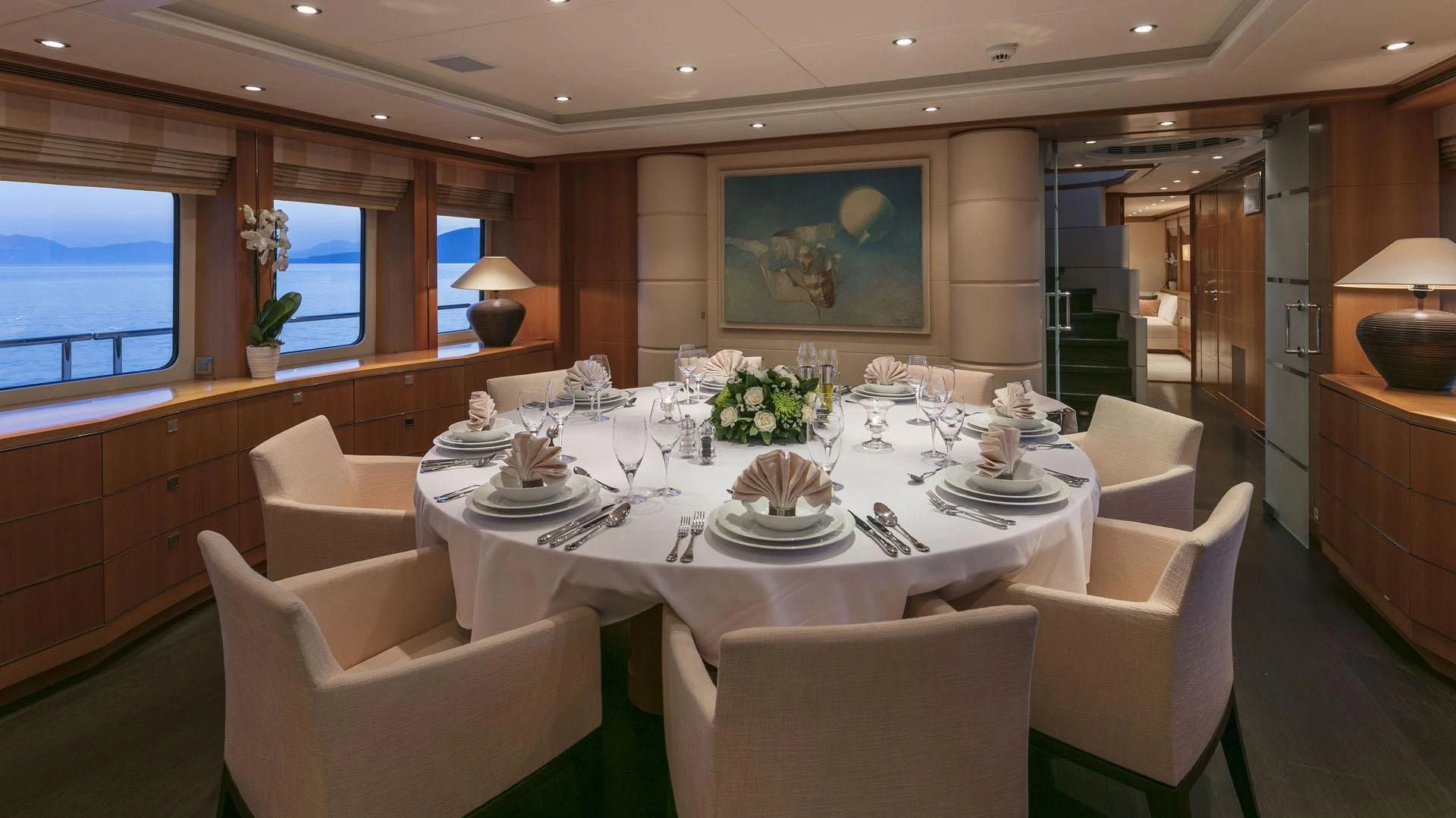 a dining room with a table set aboard L'EQUINOX Yacht for Sale