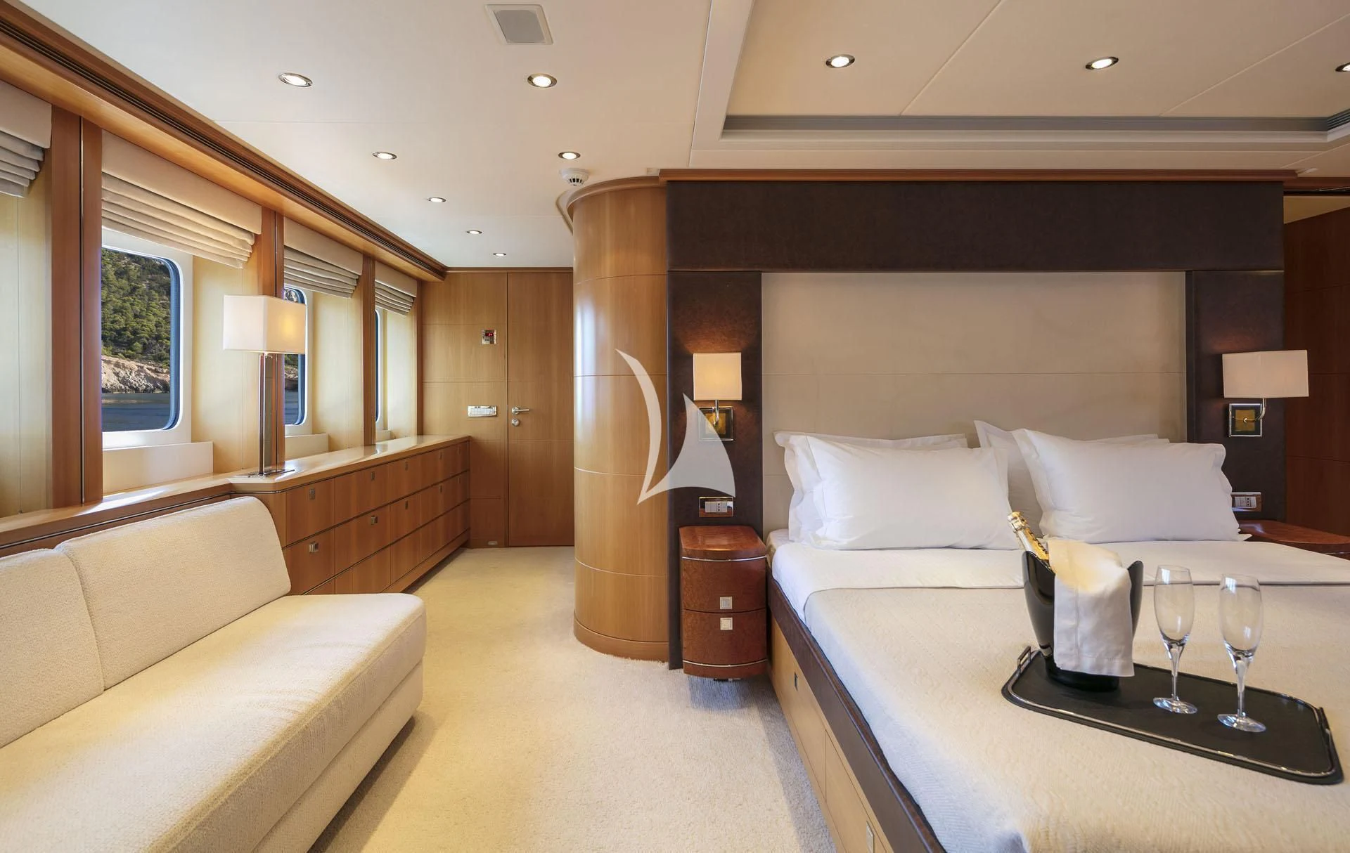a hotel room with a bed and wine glasses aboard L'EQUINOX Yacht for Sale