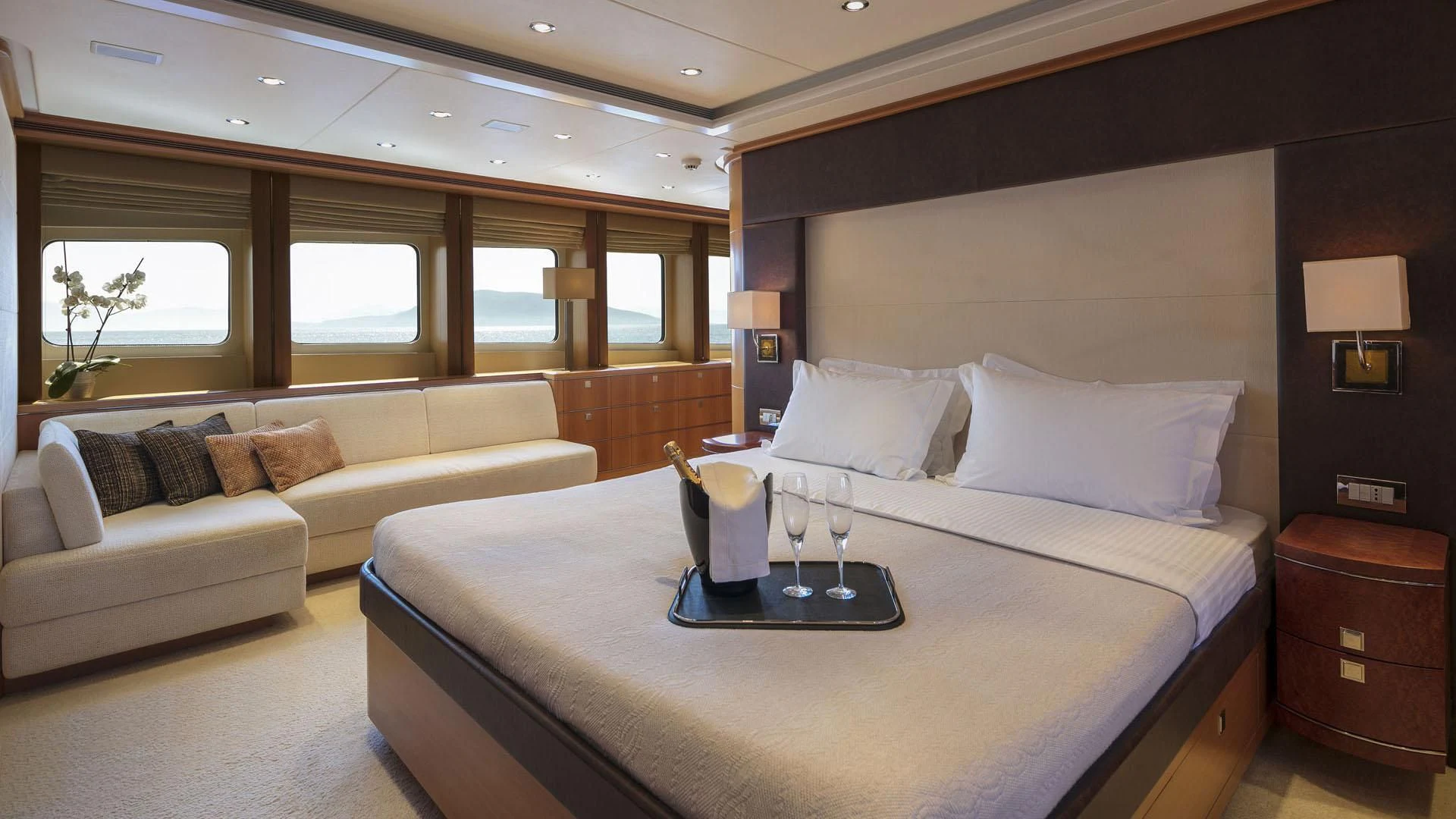 a bed with a white bed spread aboard L'EQUINOX Yacht for Sale
