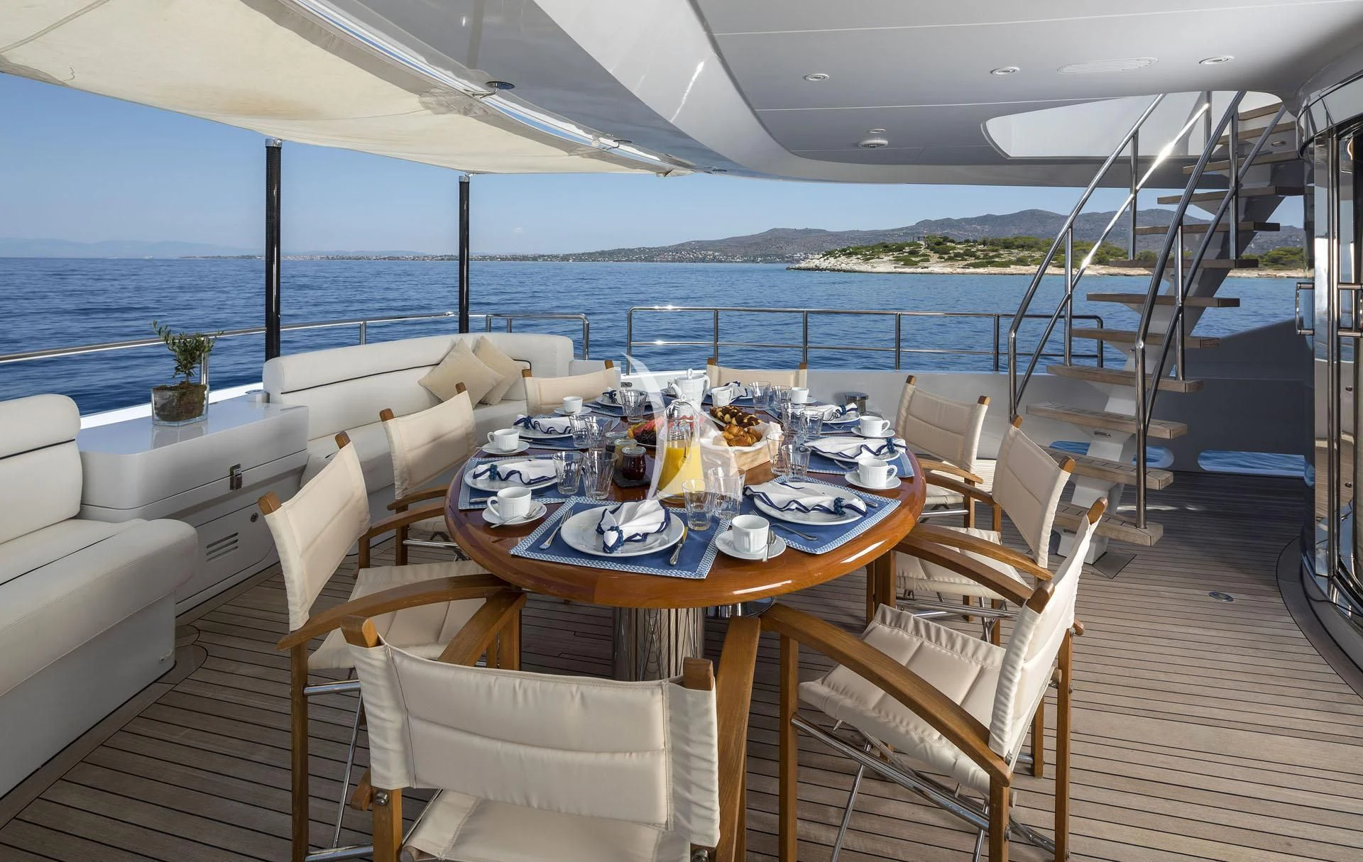 a table set for a meal on a deck aboard L'EQUINOX Yacht for Sale