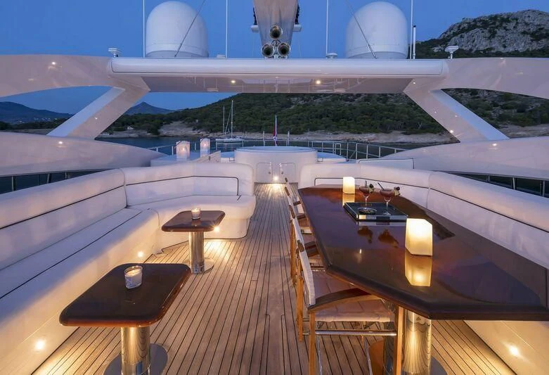 a room with a table and chairs aboard L'EQUINOX Yacht for Sale