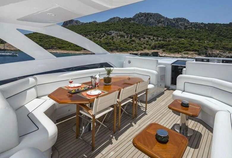 a room with a table and chairs aboard L'EQUINOX Yacht for Sale