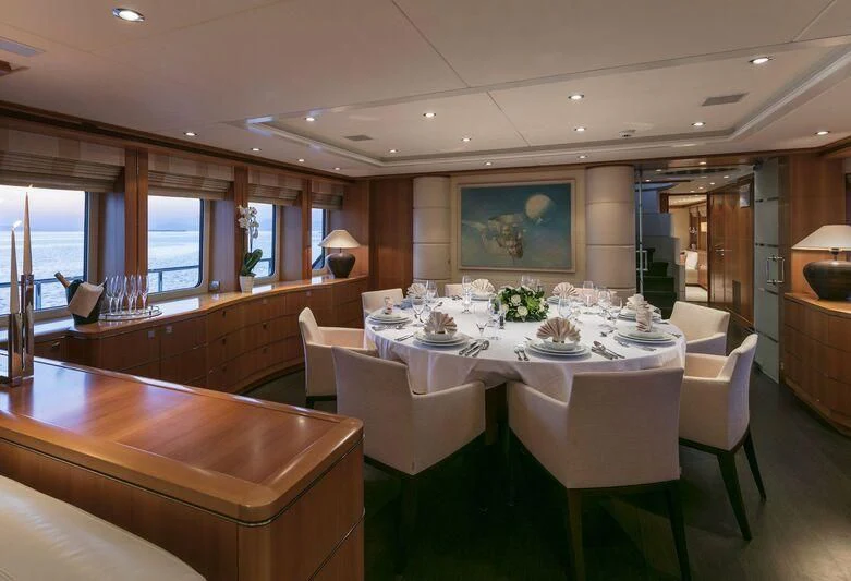 a large dining room with white tables aboard L'EQUINOX Yacht for Sale