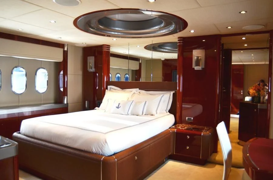 a room with a bed and a desk aboard INVICTA Yacht for Sale