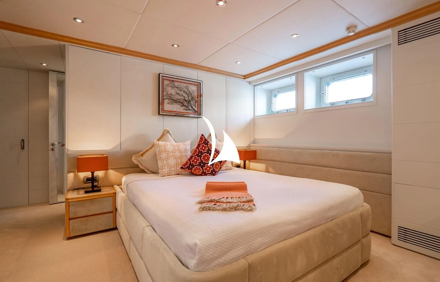 a bedroom with a bed and a lamp aboard DEEP BLUE II Yacht for Charter