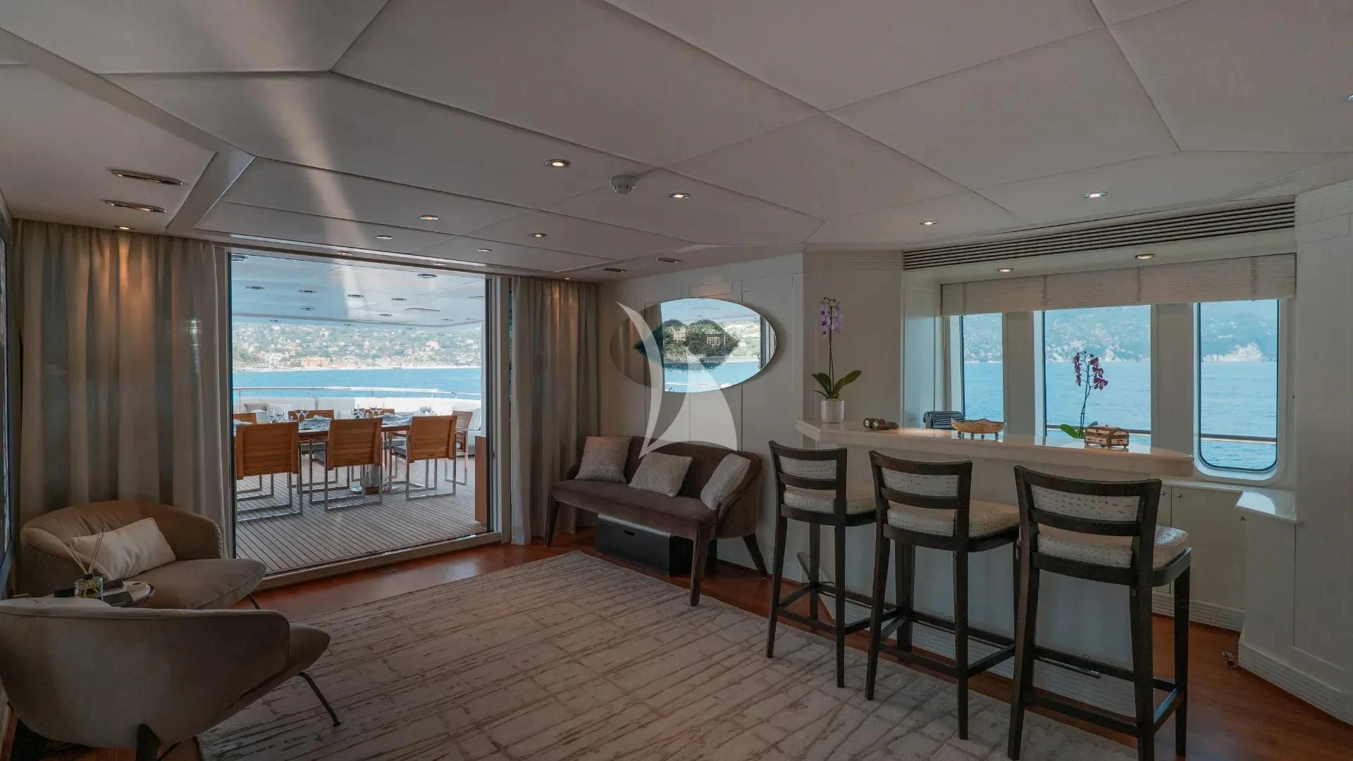 a large living room with a wood floor and a large window aboard DEEP BLUE II Yacht for Charter