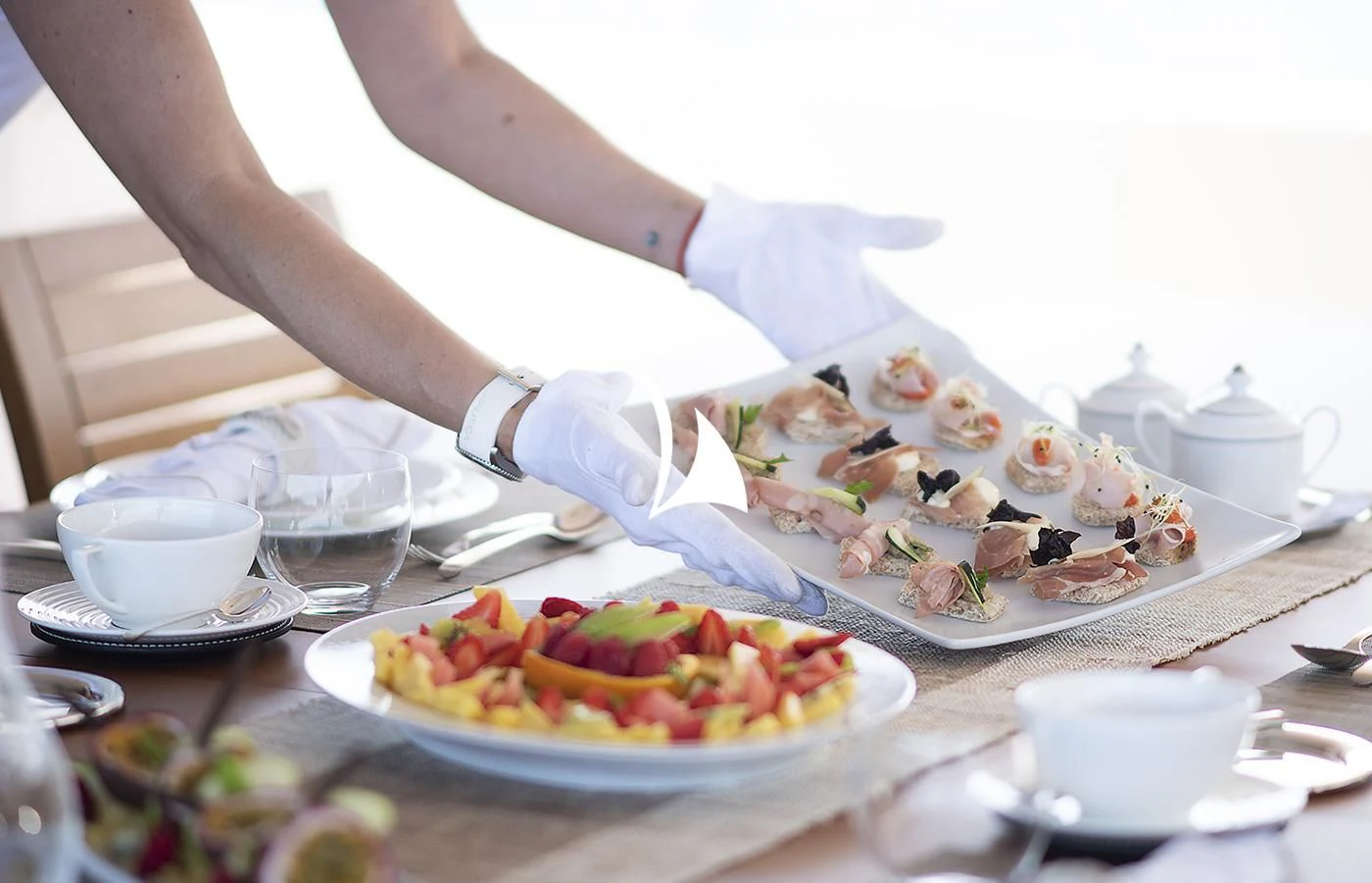 a person pouring a liquid into a glass aboard DEEP BLUE II Yacht for Charter