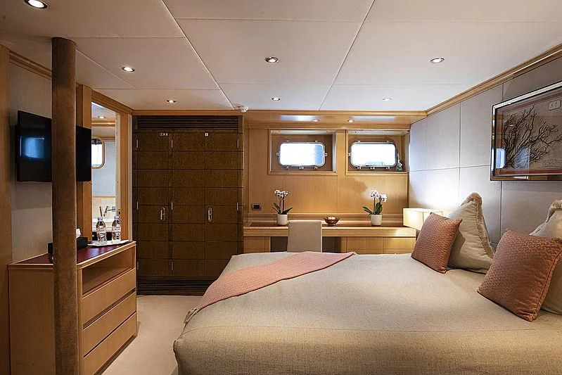 a bedroom with a bed and a tv aboard DEEP BLUE II Yacht for Charter