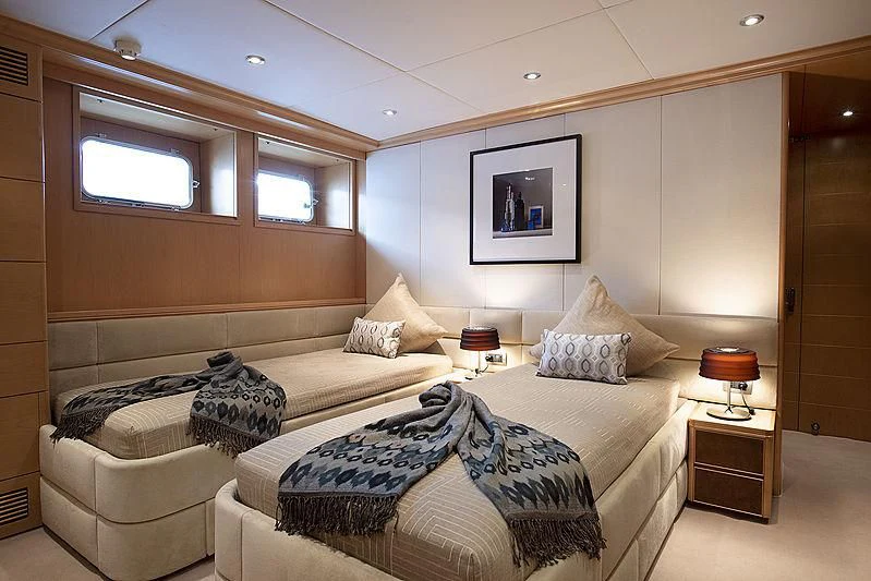 a room with a bed and a couch aboard DEEP BLUE II Yacht for Charter
