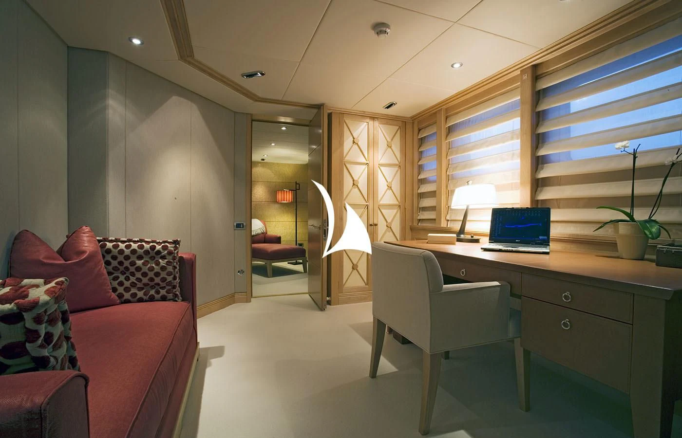 a living room with a desk and a laptop aboard DEEP BLUE II Yacht for Charter