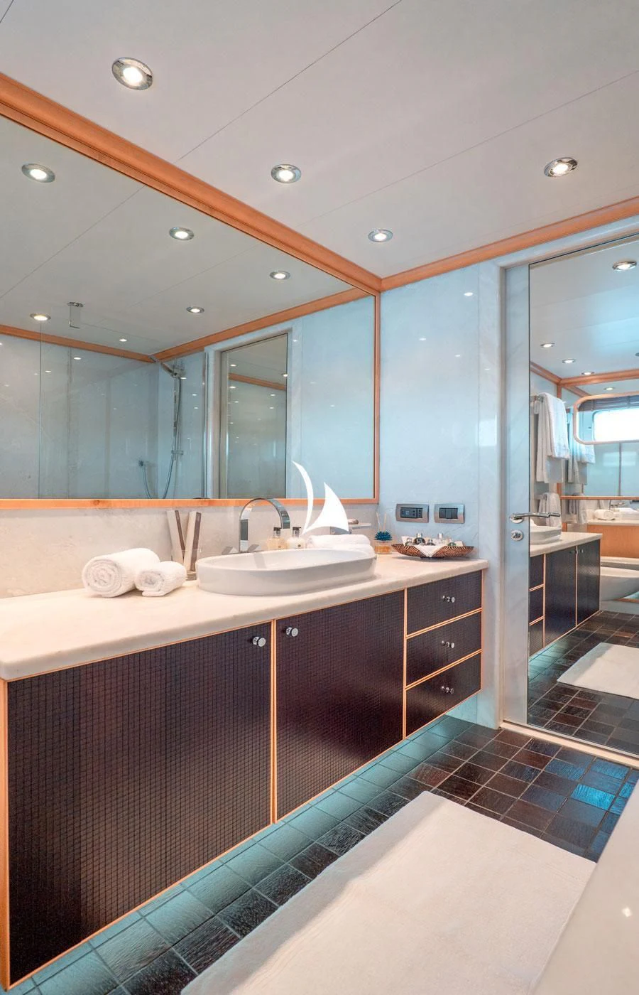 a bathroom with a sink and a mirror aboard DEEP BLUE II Yacht for Charter