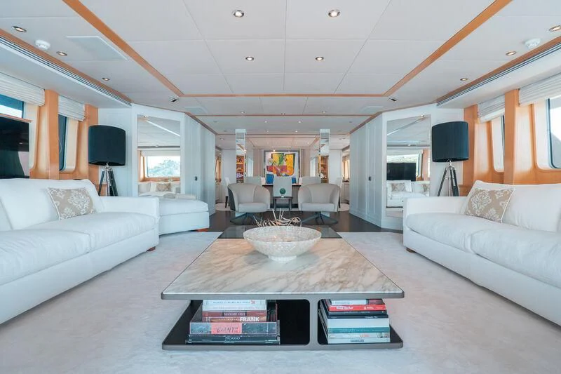 a living room with a table and couches aboard DEEP BLUE II Yacht for Charter