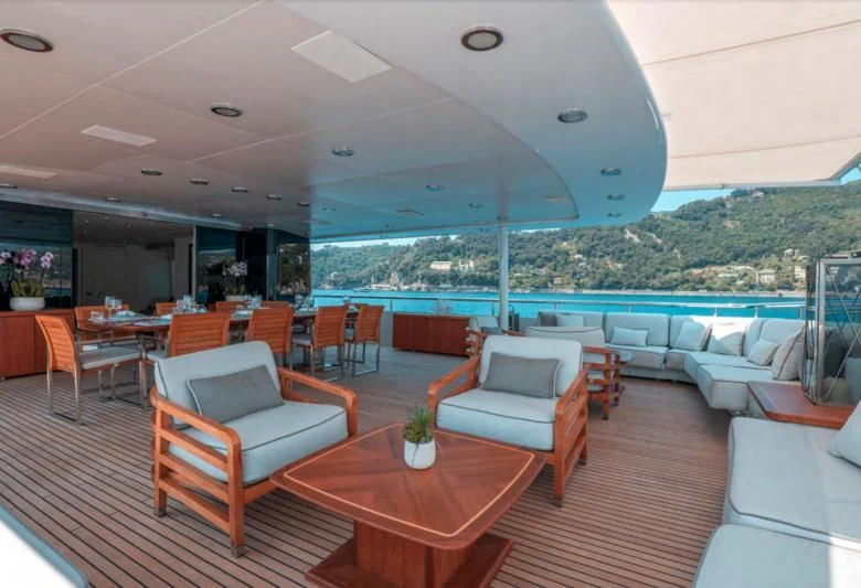 a room with a table chairs and a large window aboard DEEP BLUE II Yacht for Charter