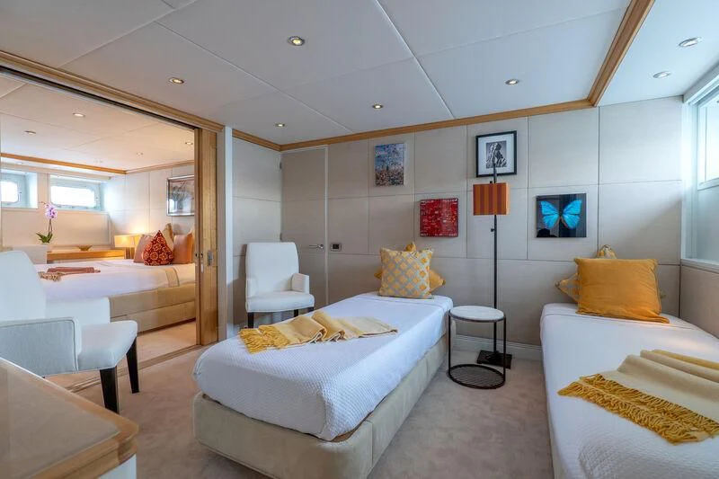 a bedroom with a bed and a lamp aboard DEEP BLUE II Yacht for Charter