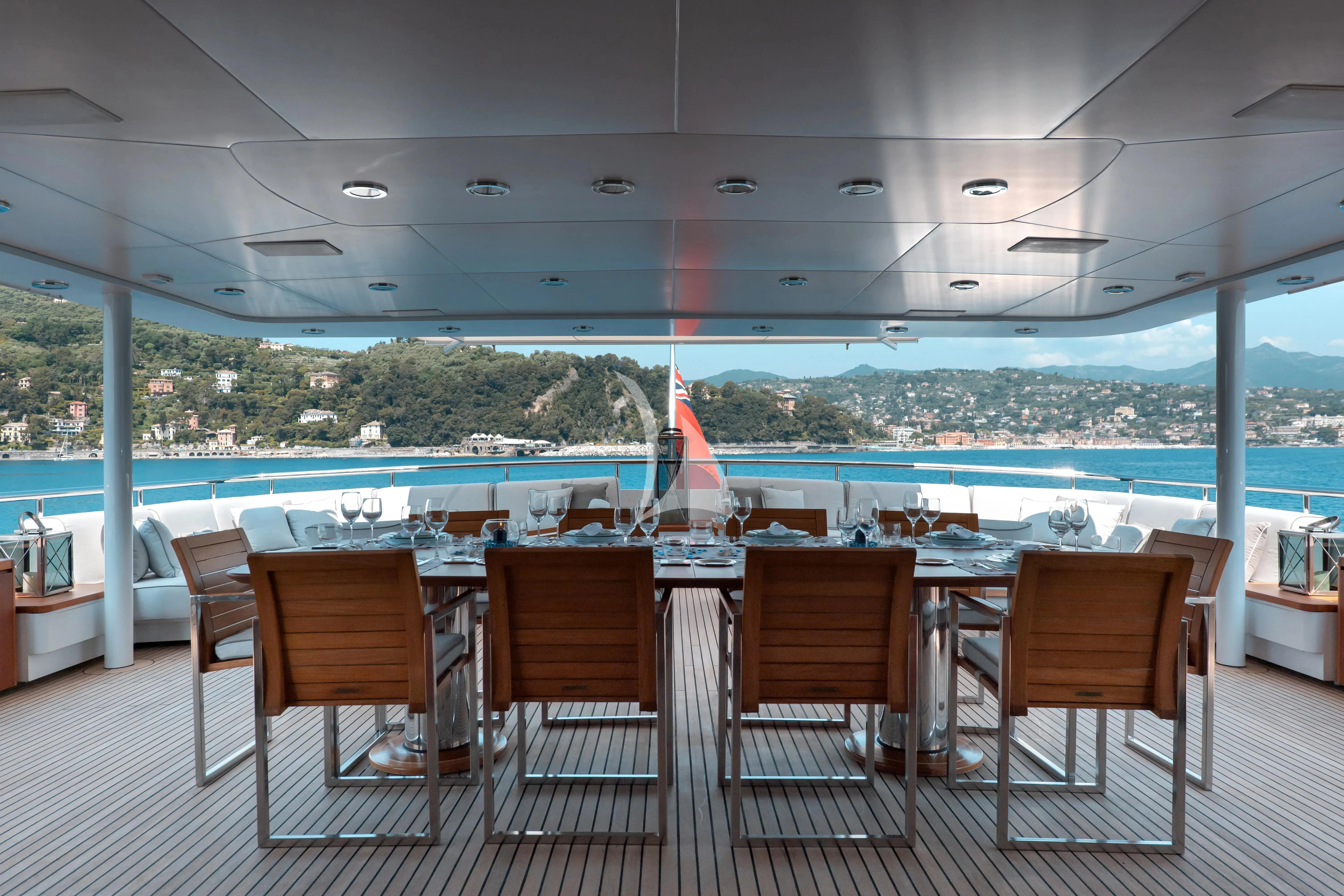 a table with chairs and a pool aboard DEEP BLUE II Yacht for Charter