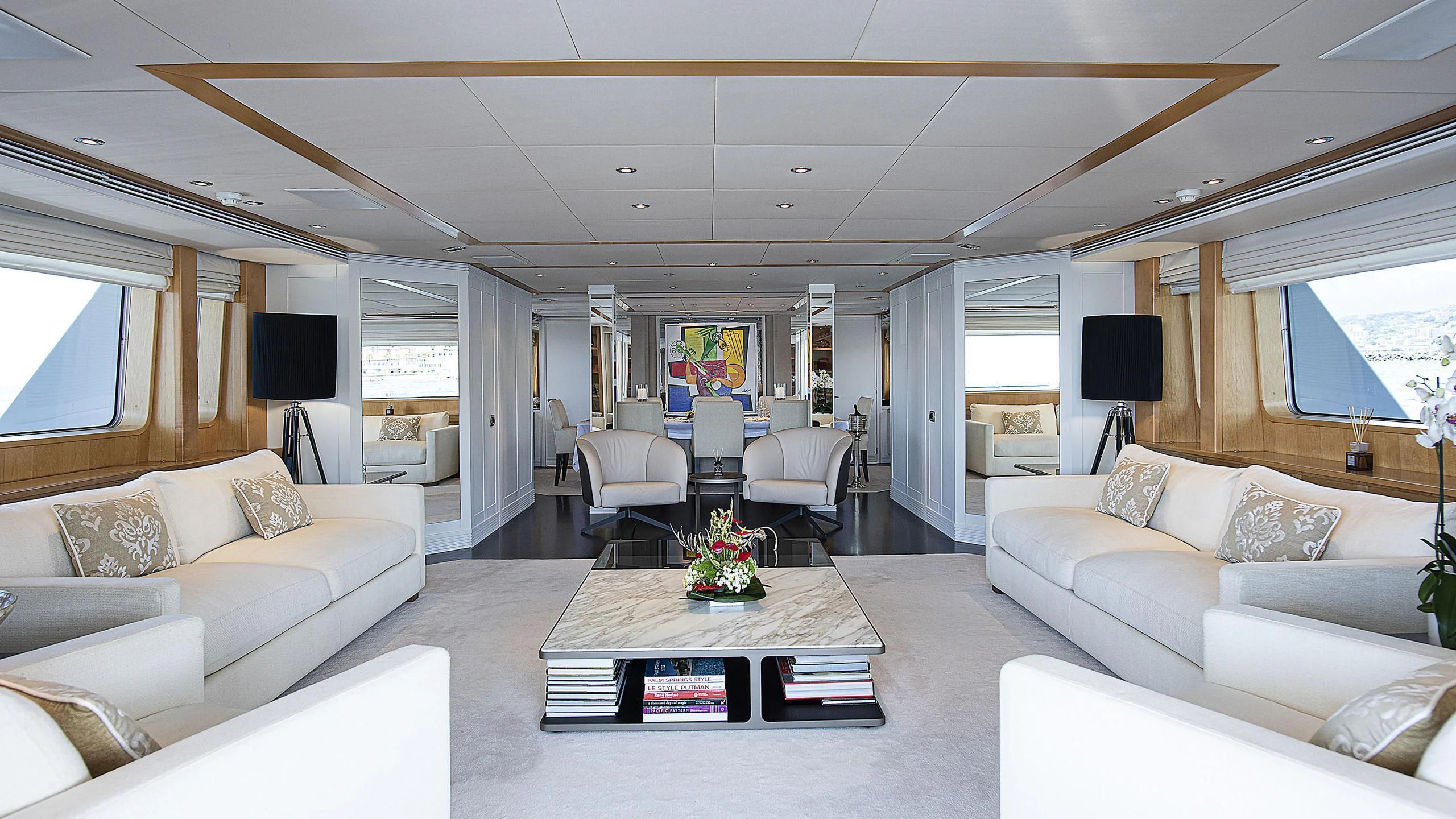 a living room with white furniture aboard DEEP BLUE II Yacht for Charter