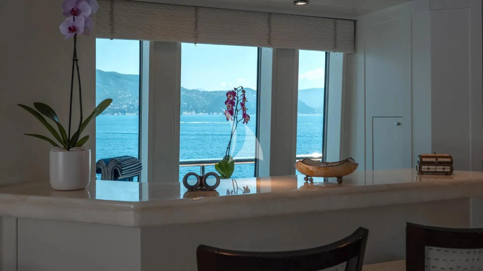 a table with a vase and flowers aboard DEEP BLUE II Yacht for Charter