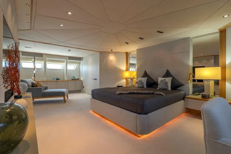 a large living room with a large blue couch aboard DEEP BLUE II Yacht for Charter