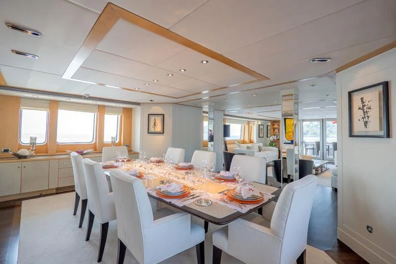 a dining room with a table and chairs aboard DEEP BLUE II Yacht for Charter