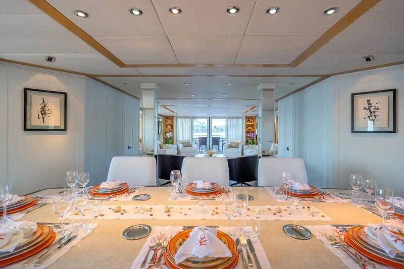 a large dining room with a table set for a meal aboard DEEP BLUE II Yacht for Charter