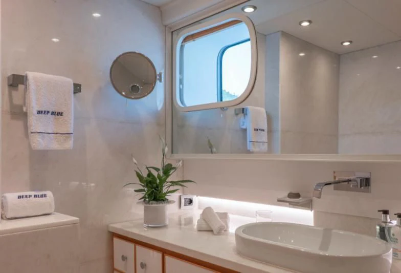 a bathroom with a large mirror aboard DEEP BLUE II Yacht for Charter