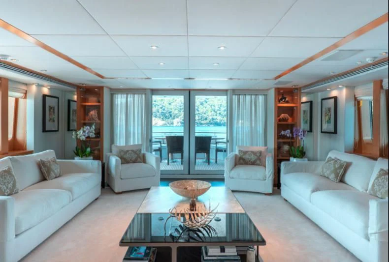 a living room with white couches and a coffee table aboard DEEP BLUE II Yacht for Charter